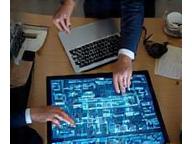 Team consulting on network infrastructure diagram